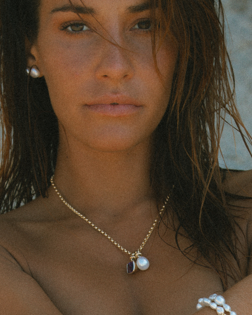 Close-up of 9k solid gold 3.34mm Italian chain with South Sea pearl and Amethyst charms.