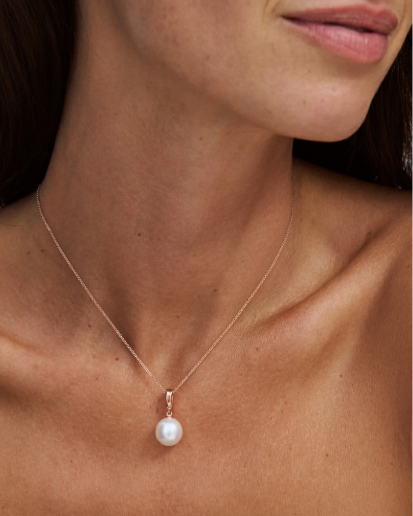 south sea pearl on a fine 9k solid gold chain with a removable pendant on a model with a plain background