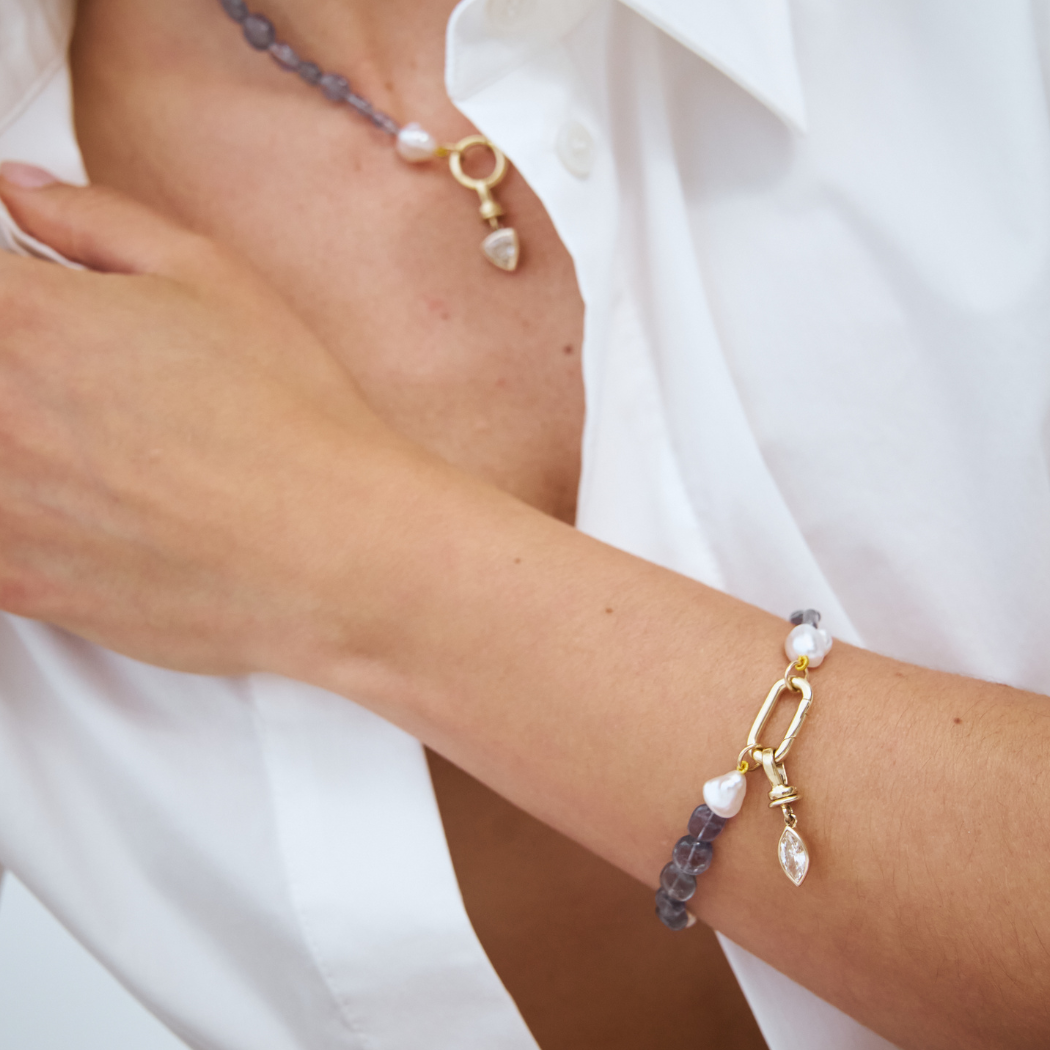 handcrafted bracelet of Keshi South Sea pearls and Iolite gemstones with 9kt gold hinged clasp and champagne diamond charm.