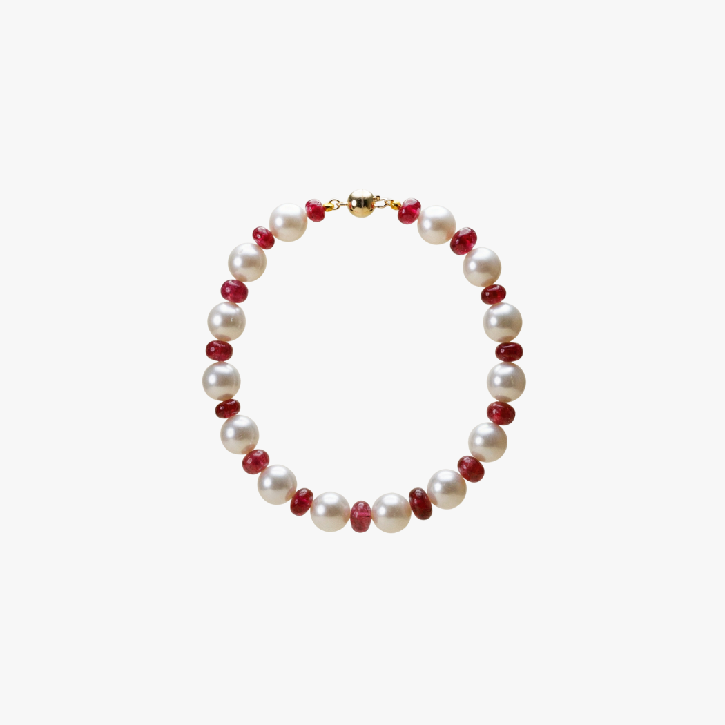 South Sea Pearl and red spinel bracelet with 9k yellow gold clasp on a white background