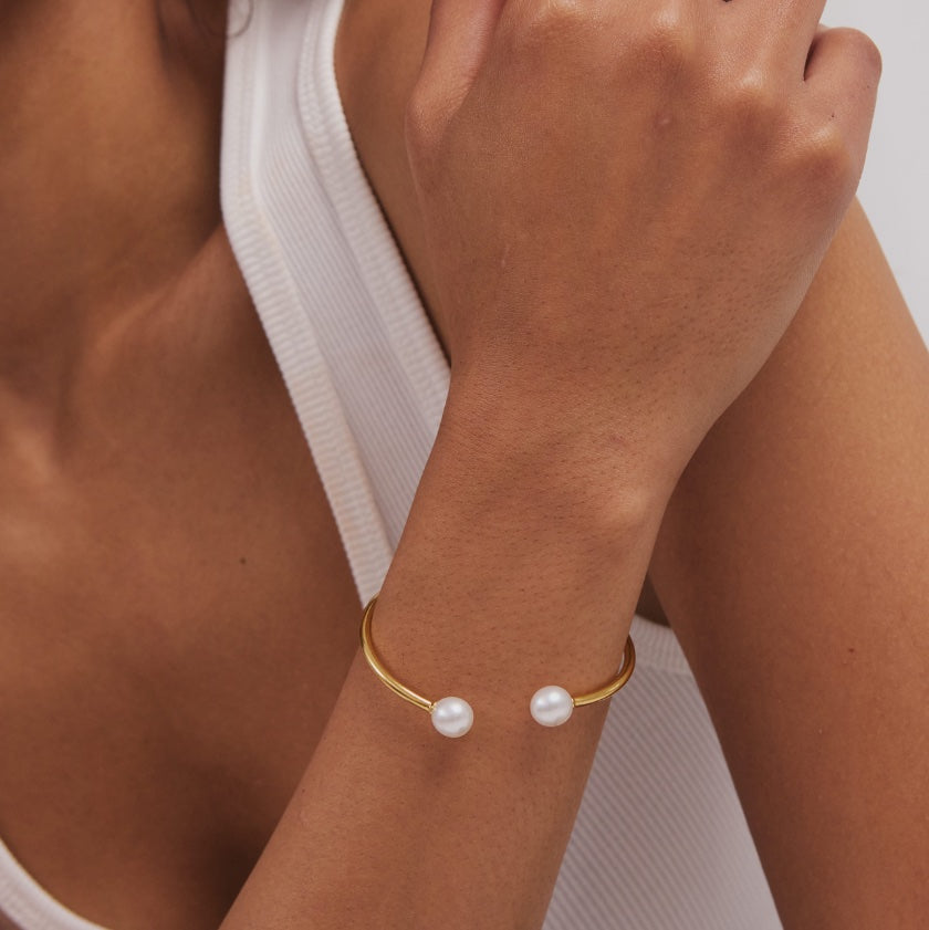 Valentina Bangle worn on model – gold bangle with South Sea pearl charm, Autore Moda