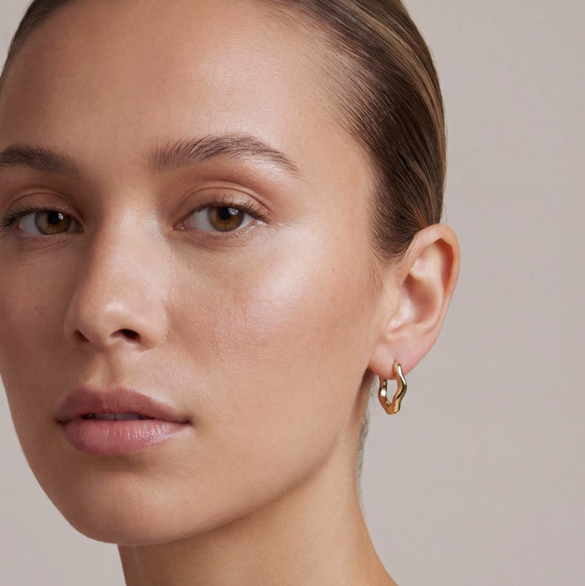 Woman wearing gold hoop earrings