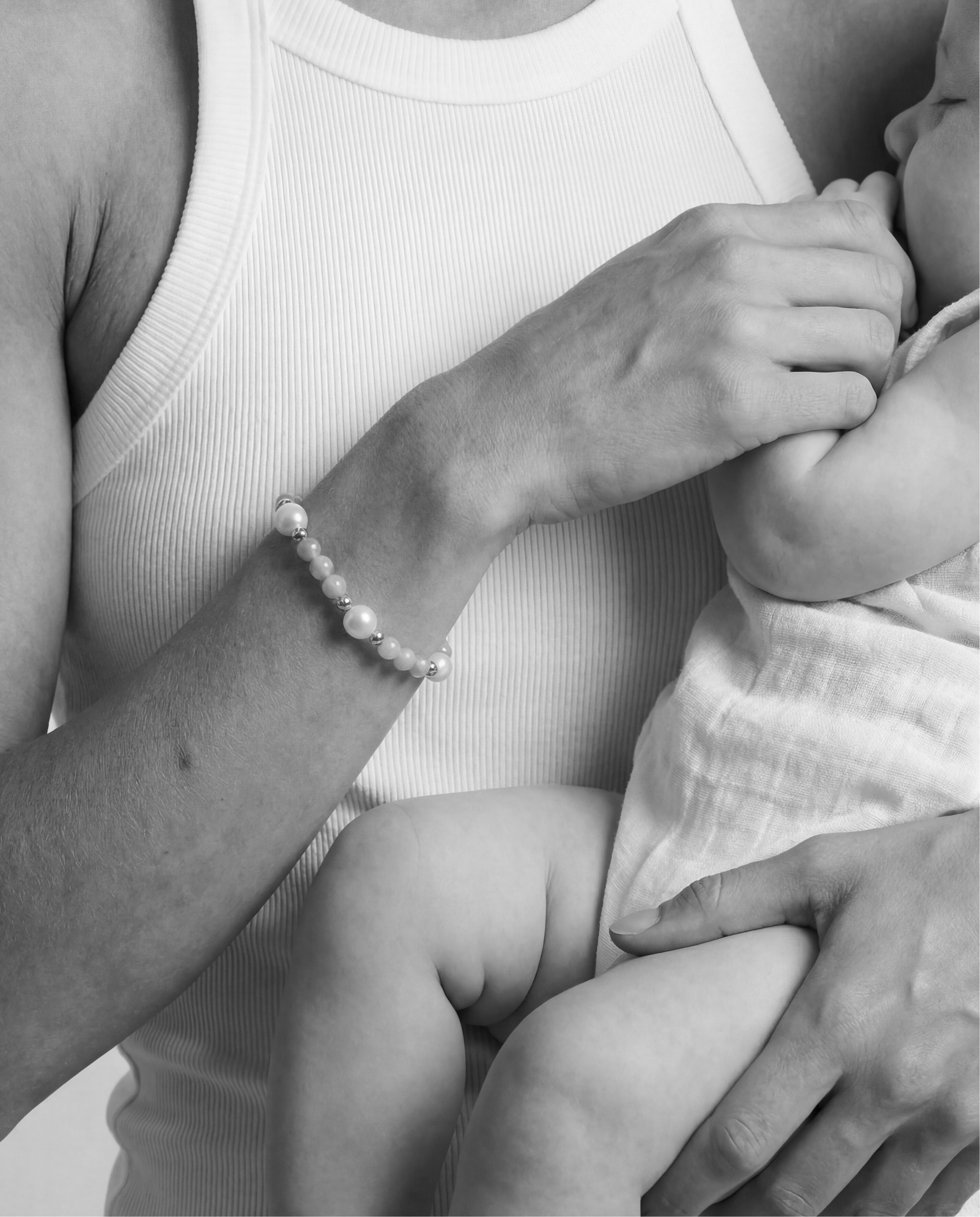 Black and white photo of a woman holding a baby