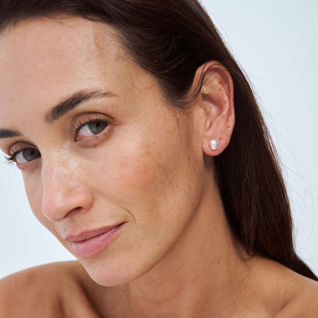 South Sea Keshi Stud Earrings (6-7mm) worn by a model in her ear.