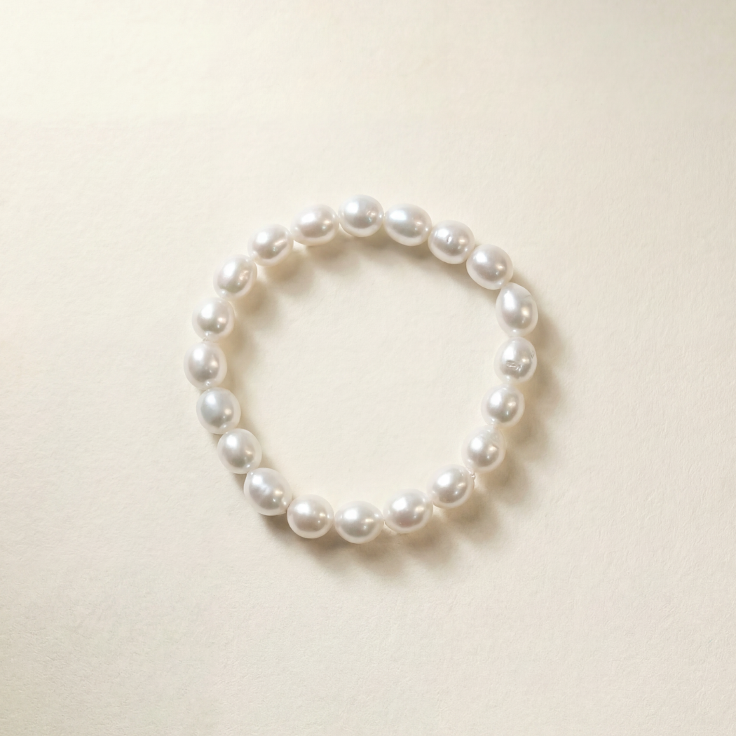 Pearl bracelet on a light beige background