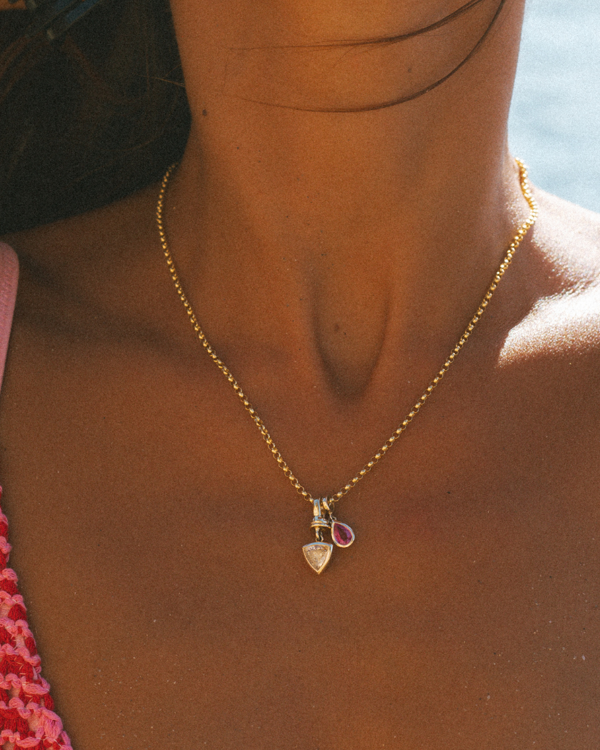 Close-up of 9k solid gold Italian chain with solid gold Trilliant Diamond and Pink Sapphire charms.