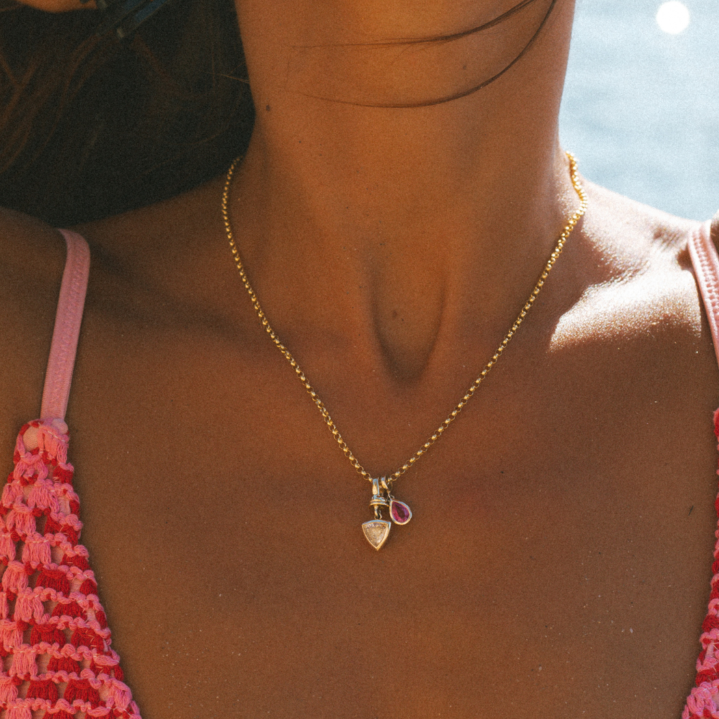 Close-up of 9k solid gold Italian chain with bezel cut solid gold Trilliant Diamond and Pink Sapphire charms.