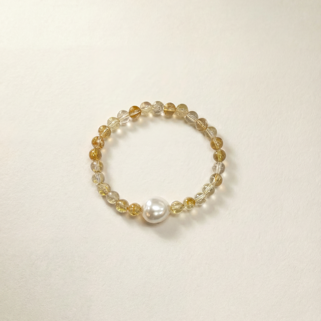 Beaded bracelet with pearls on a light beige background