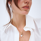 model wearing a 9k gold belcher chain with a south sea pearl and diamond charm.