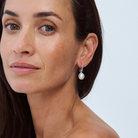Close-up of a model wearing a South Sea pearl drop earring on a 9k solid gold hoop.