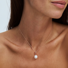 south sea pearl on a fine 9k solid gold chain with a removable pendant on a model with a plain background 