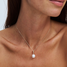 south sea pearl on a fine 9k solid gold chain with a removable pendant on a model with a plain background 