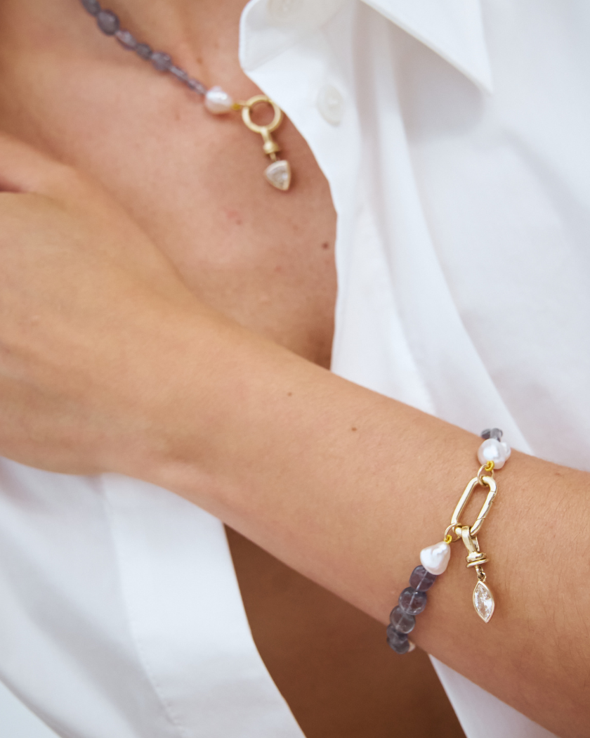 handcrafted bracelet of Keshi South Sea pearls and Iolite gemstones with  9kt gold hinged clasp and champagne diamond charm.