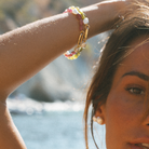 Up close on arm wearing Keshi South Sea pearls and gemstone bracelets with 9kt gold hinged clasp designed for personalising with your own charms.