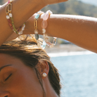 Layered close up of multiple South Sea Keshi pearl and gemstone bracelets with 9k solid gold hinged clasp made for adding personalised charms.