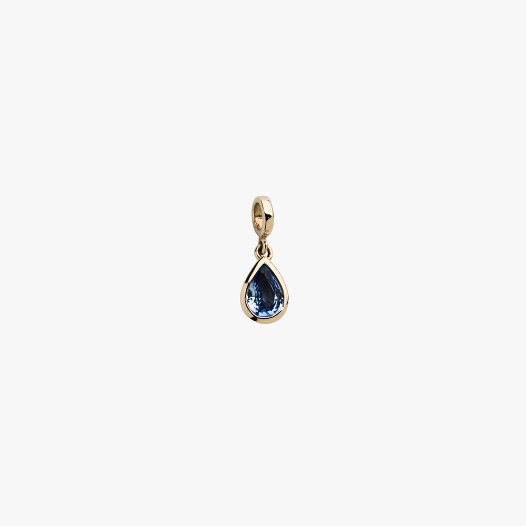 9k solid gold bezel-set blue sapphire charm with hinged clasp for personalising your own necklace or bracelet.