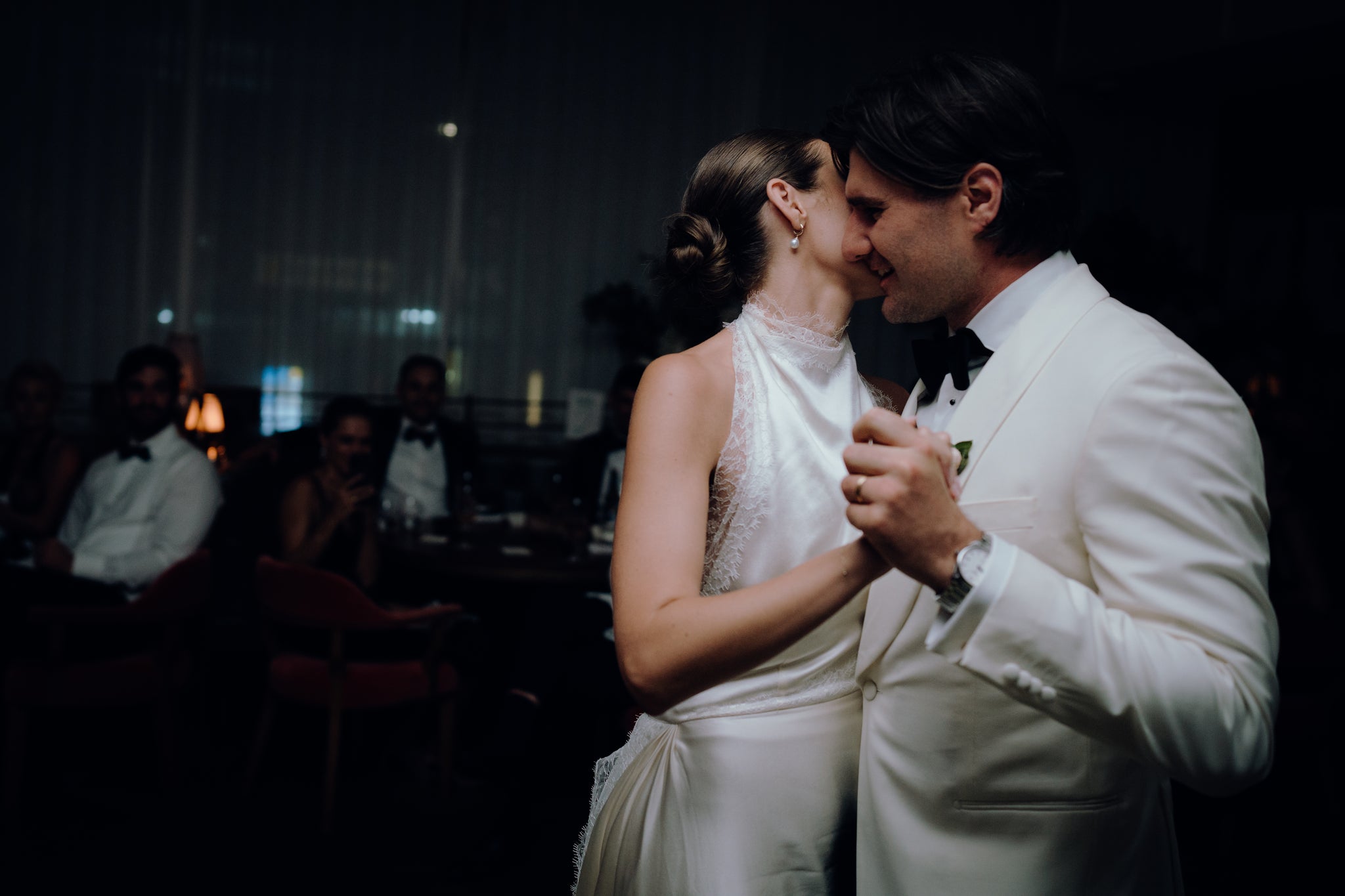 Bride and groom's first dance at their wedding reception, bride wearing an AUTORE MODA pearl drop earring