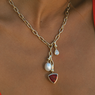 Close-up of 9k solid gold Italian chain necklace with South Sea pearl gemstone charms.