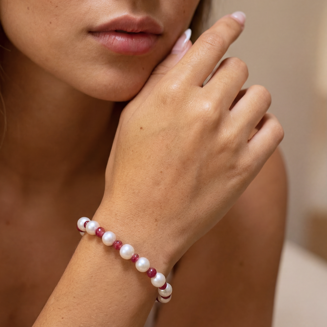 South Sea Pearl and red spinel bracelet with 9k yellow gold clasp on a models hand