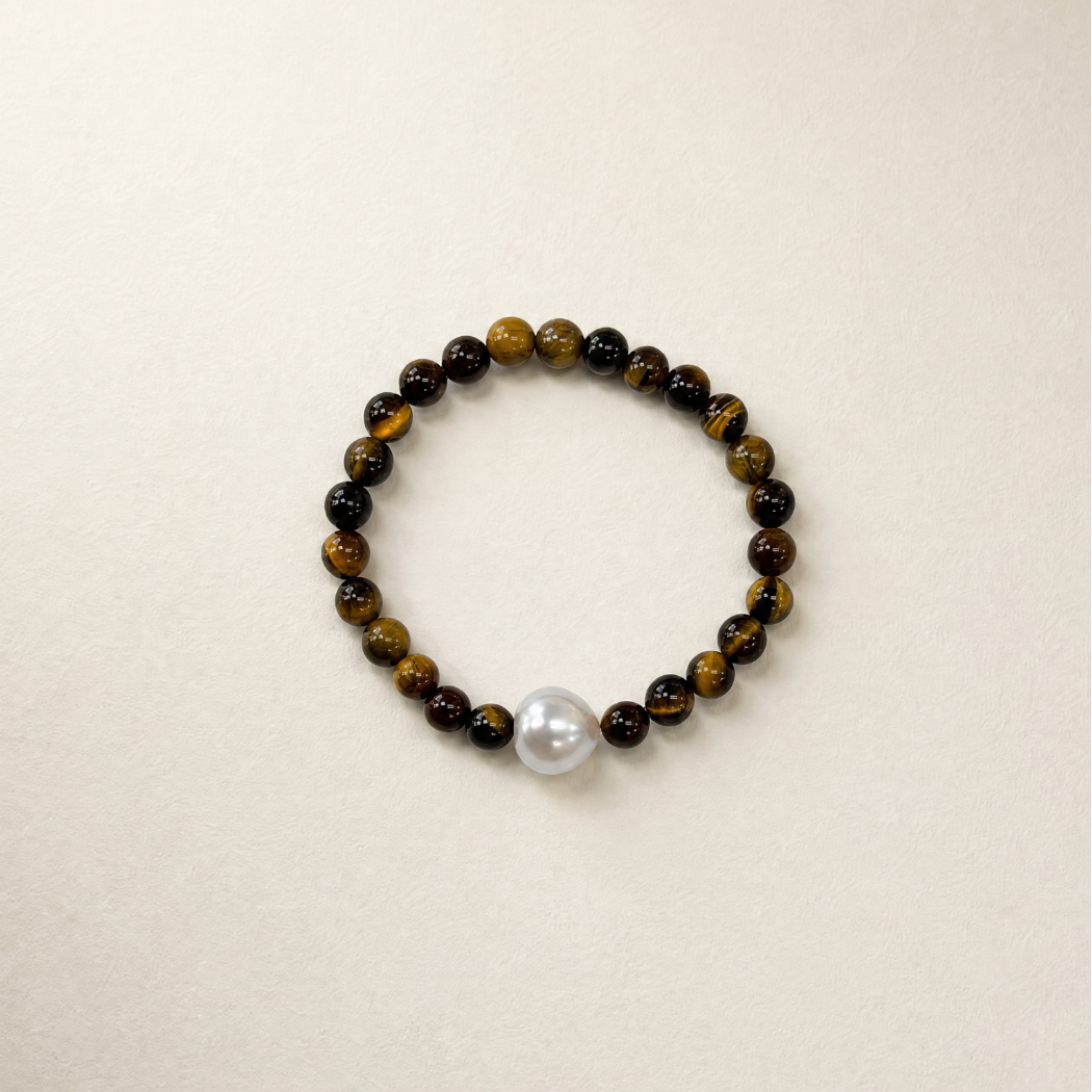 Beaded bracelet with a pearl on a beige background