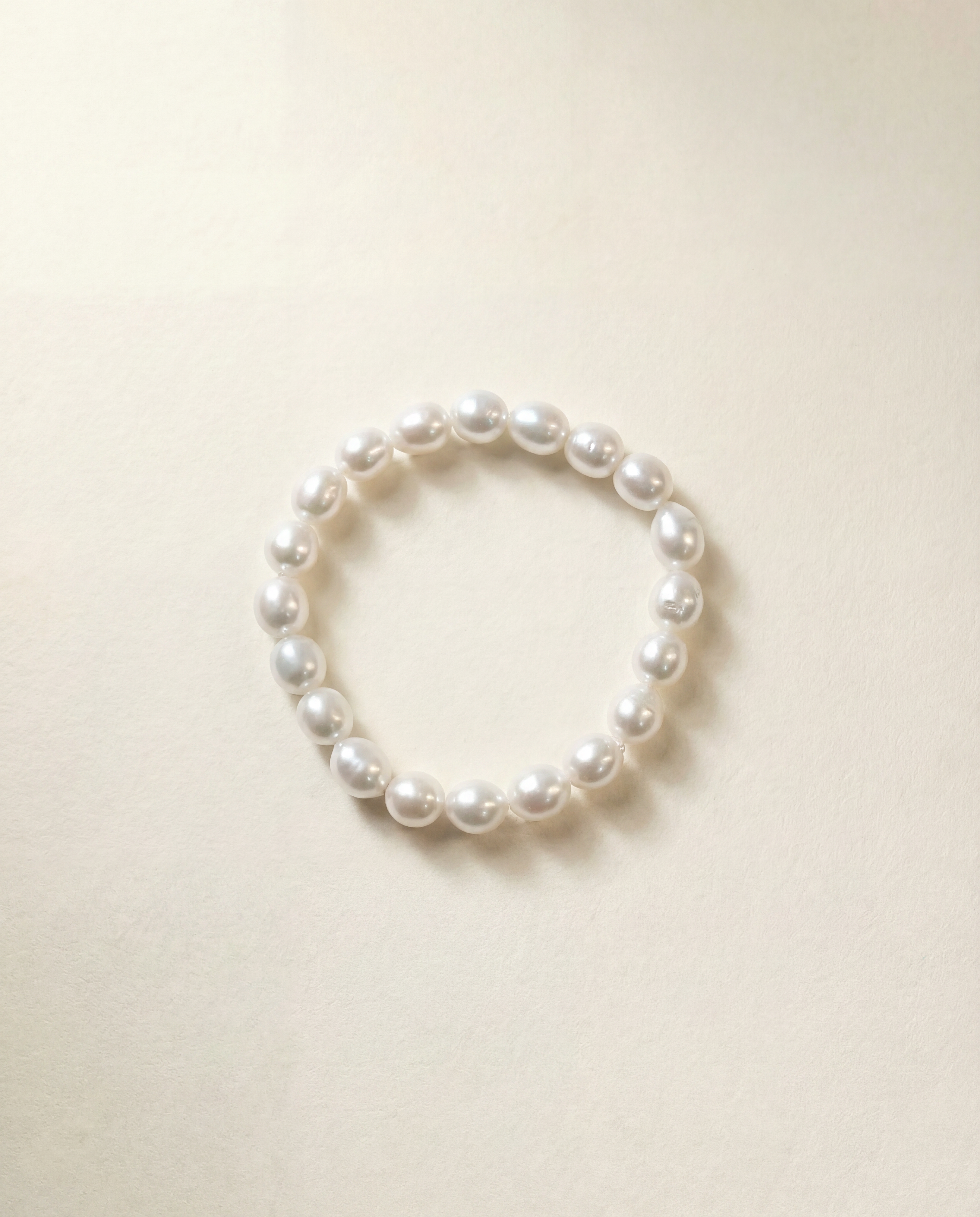 Pearl bracelet on a light beige background