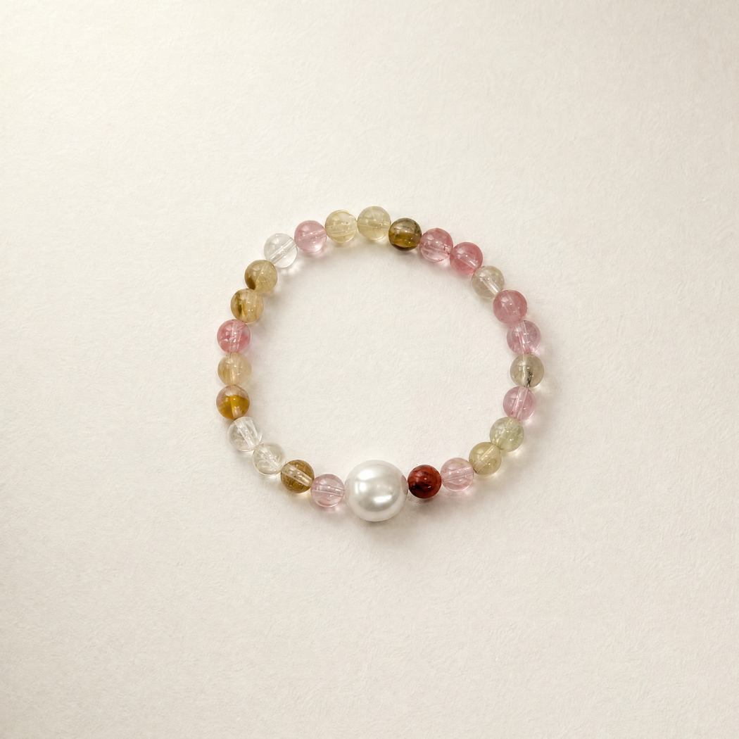 watermelon quartz beaded bracelet with a pearl on a beige background
