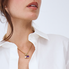 Belcher chain necklace with an amethyst and diamond charm worn by a model.