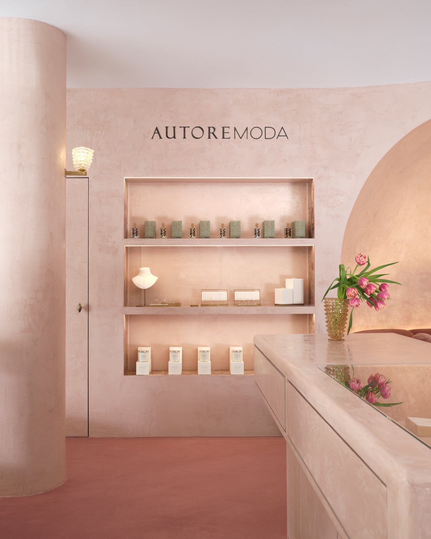 Interior of a store with 'AUTOREMODA' branding, shelves with products, and decorative elements.