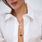 model wearing a 9k gold belcher chain with a layered rubelite and south sea pearl charm.