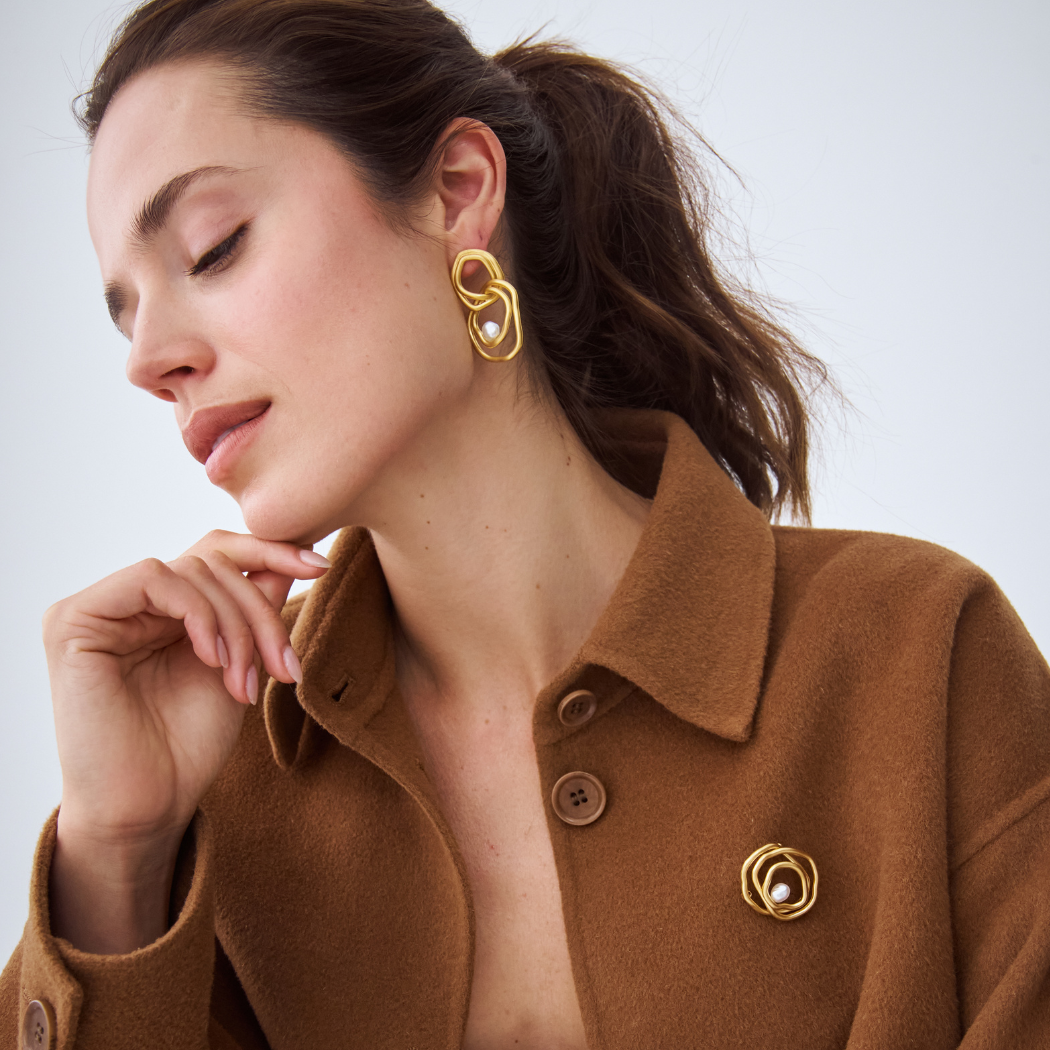 Celeste Statement Earrings and Brooch with south sea keshi pearl in 18k yellow gold vermeil on model. 