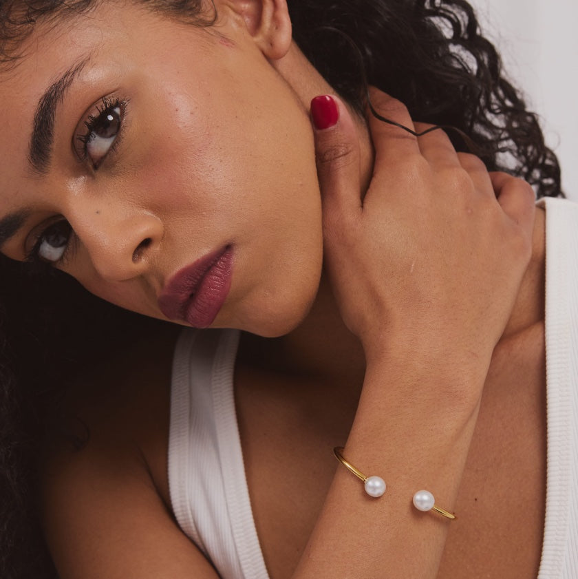 Valentina Bangle worn on model – gold bangle with South Sea pearl charm, Autore Moda